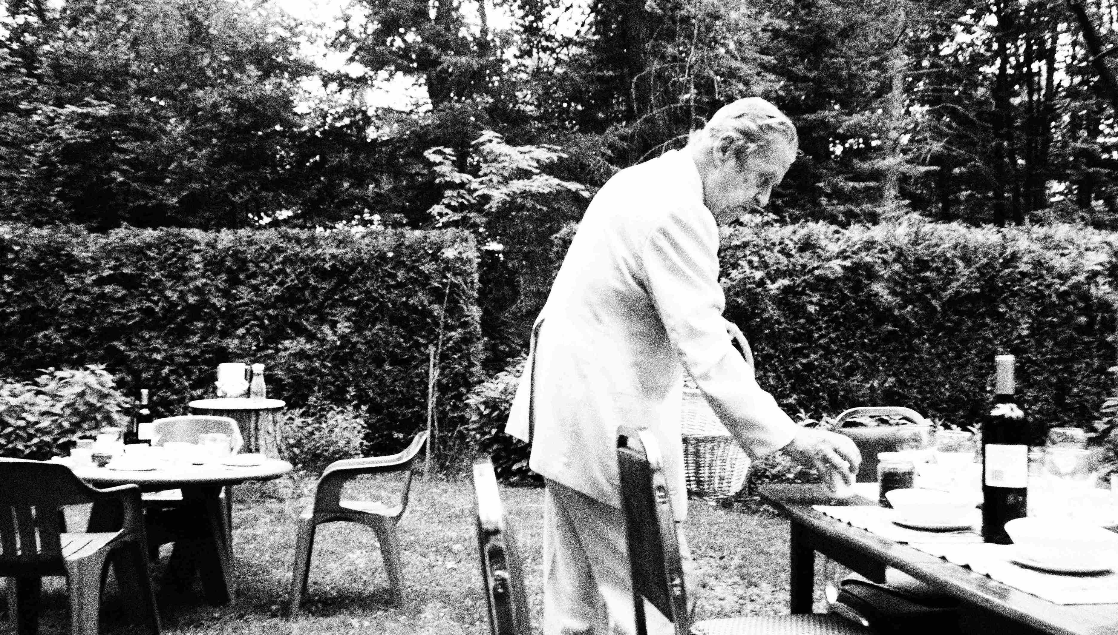 Kazio prepares the tables in the garden